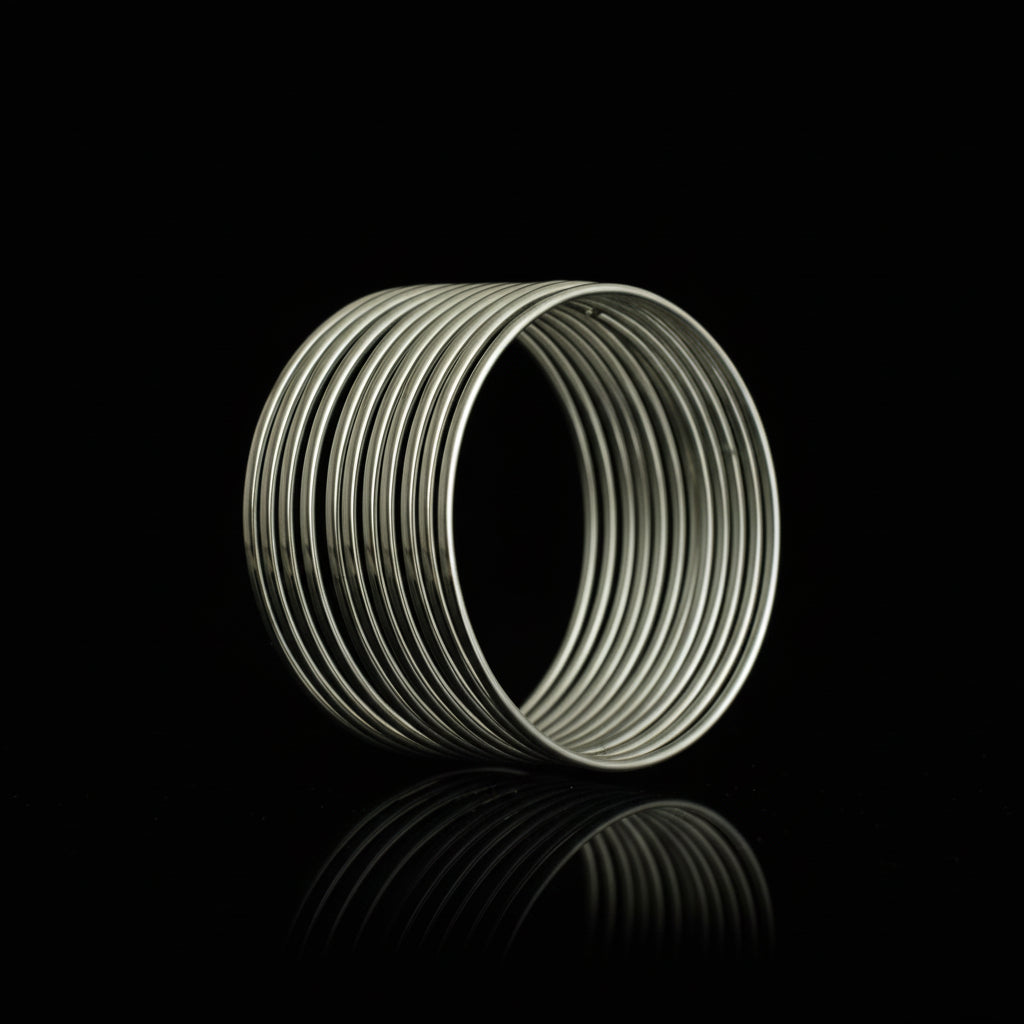 Coiled white cable on a black stand against a dark background