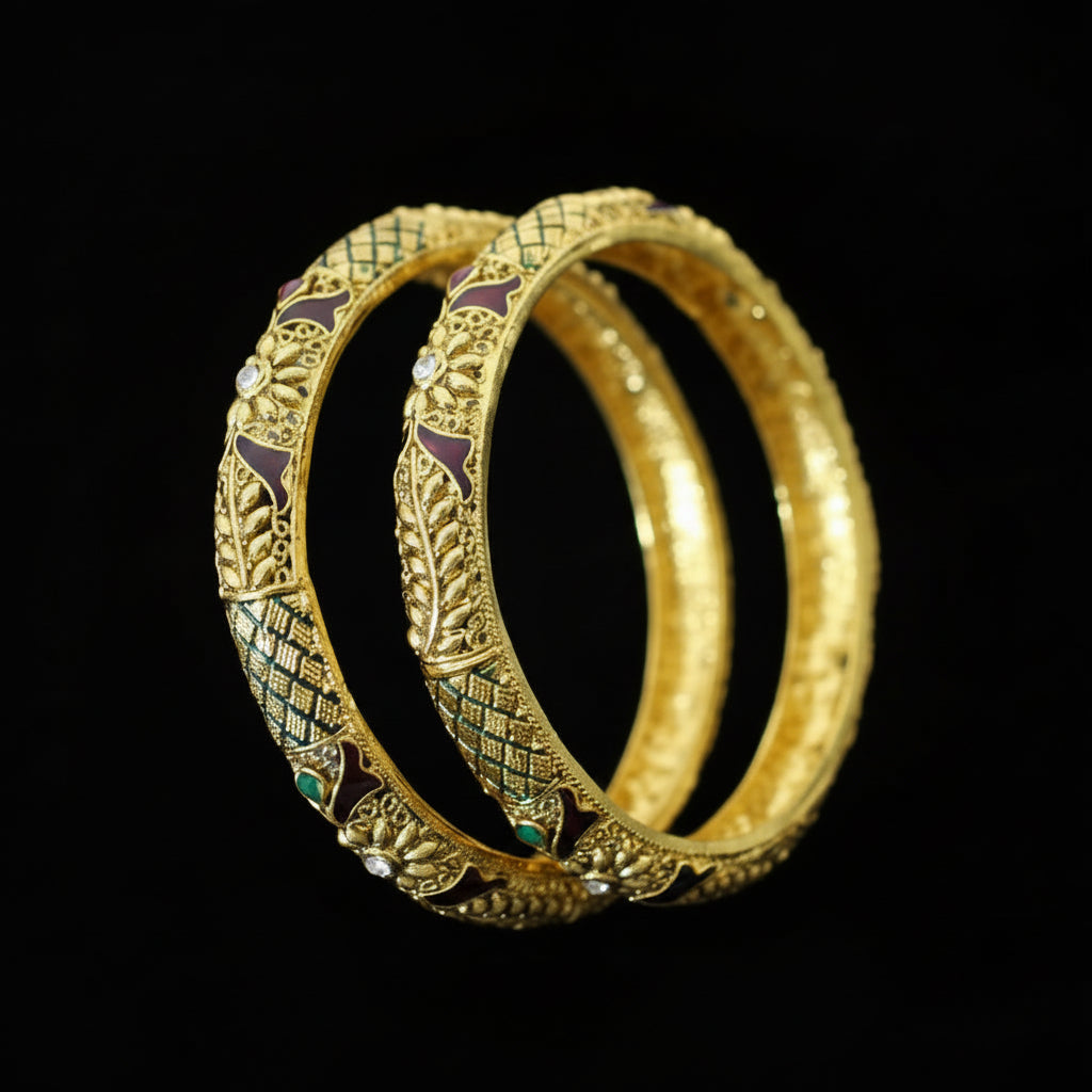 Gold bangles with intricate designs on a gray background, featuring the brand 'SAHELLI'.