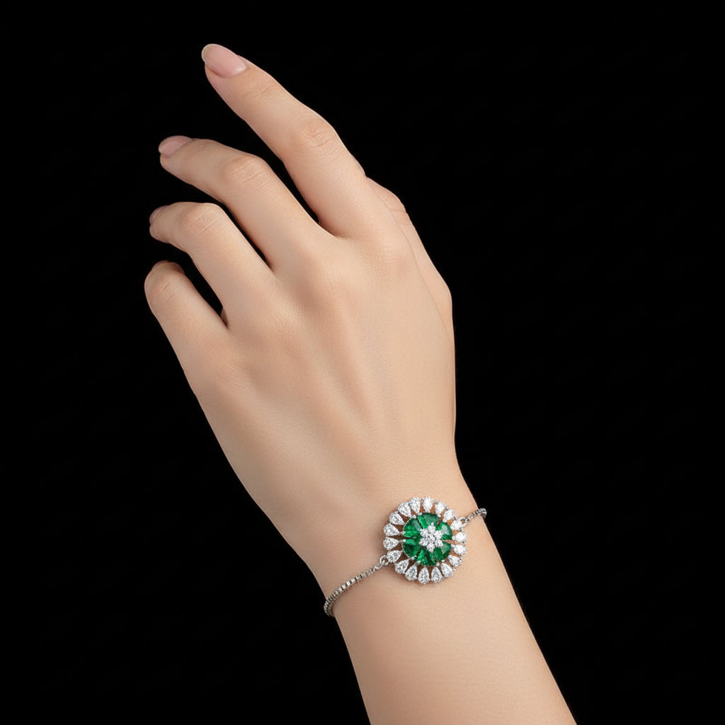 Silver bracelet with green gemstone on a gray background, featuring the brand 'SAHELI'.