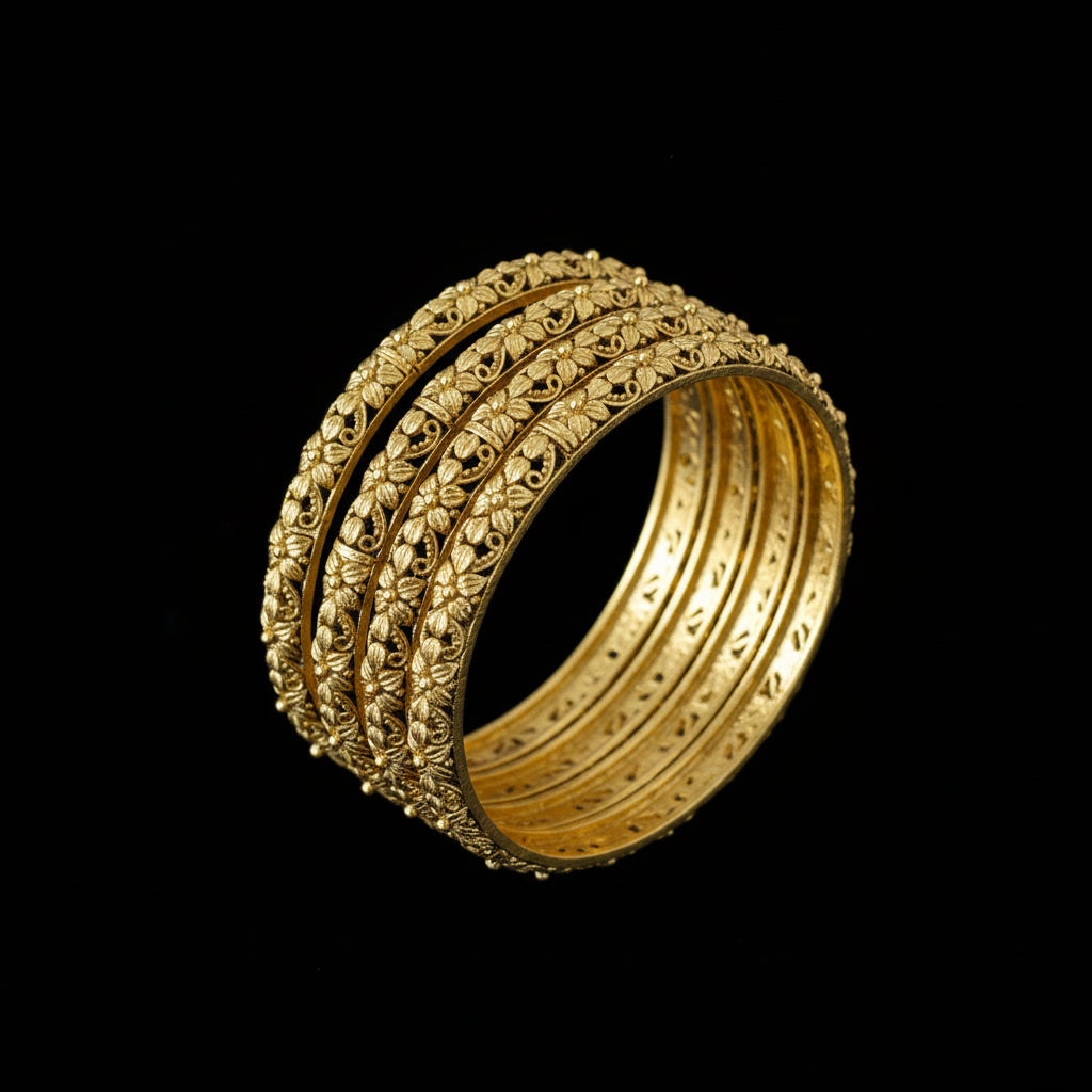 Gold bangles on a gray stand with 'SAHELI' branding.