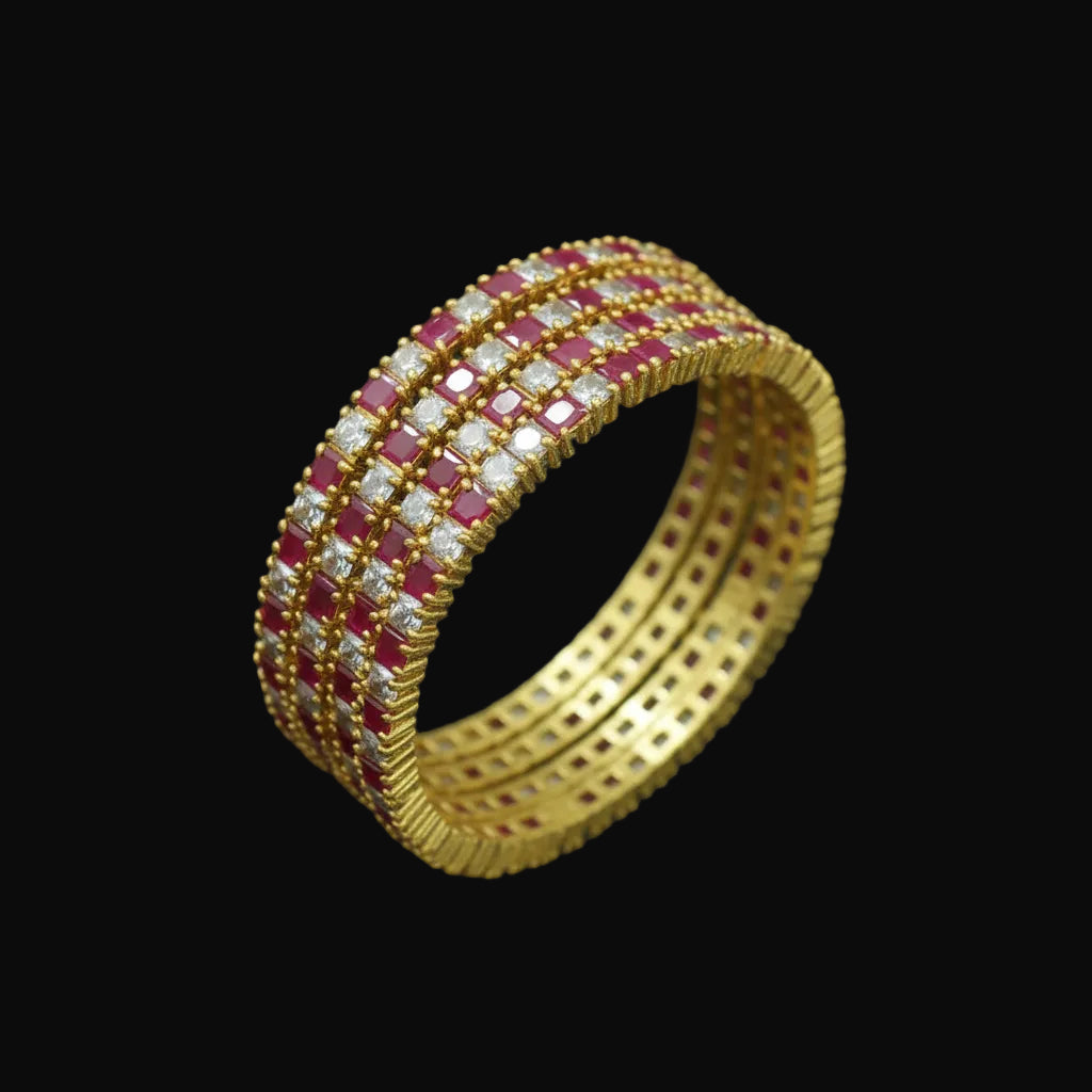Gold bangles with red and white stones on a black background, branded 'Saheli'.