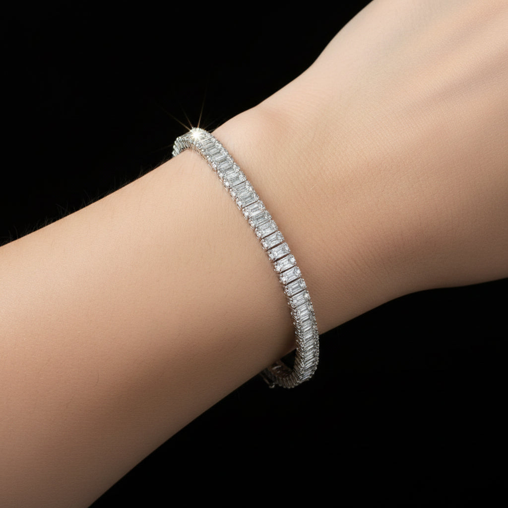 Silver bracelet on a reflective black surface