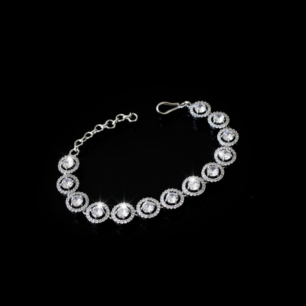 Silver bracelet with circular design on a dark background