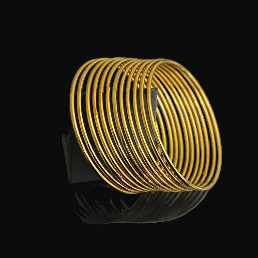 Gold bracelet on a dark gray background
