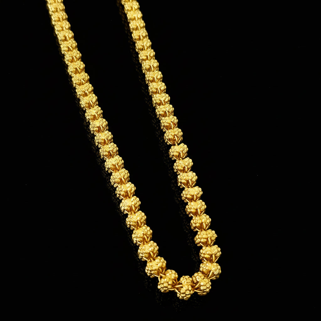 Gold chain necklace on a gray background with 'SAHELI' branding.