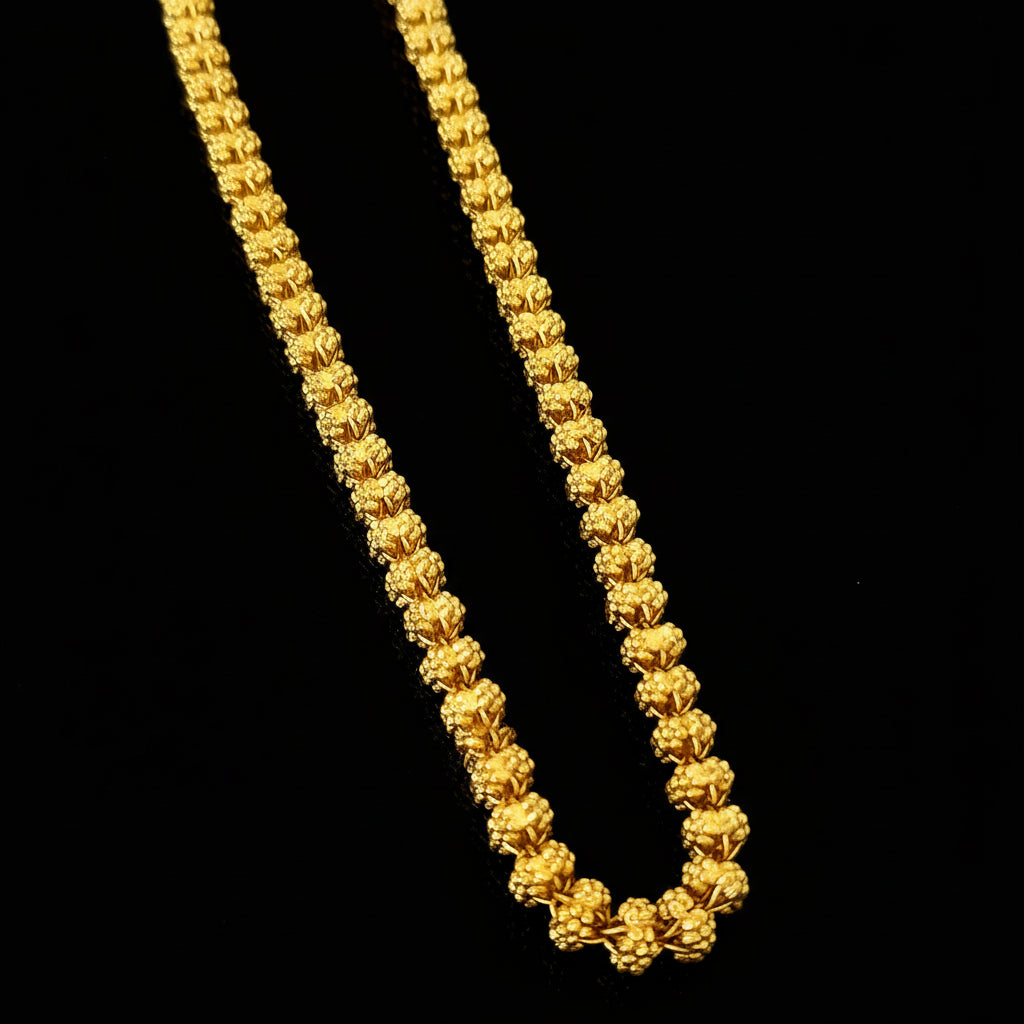 Gold chain necklace on a gray background with 'SAHELI' branding.