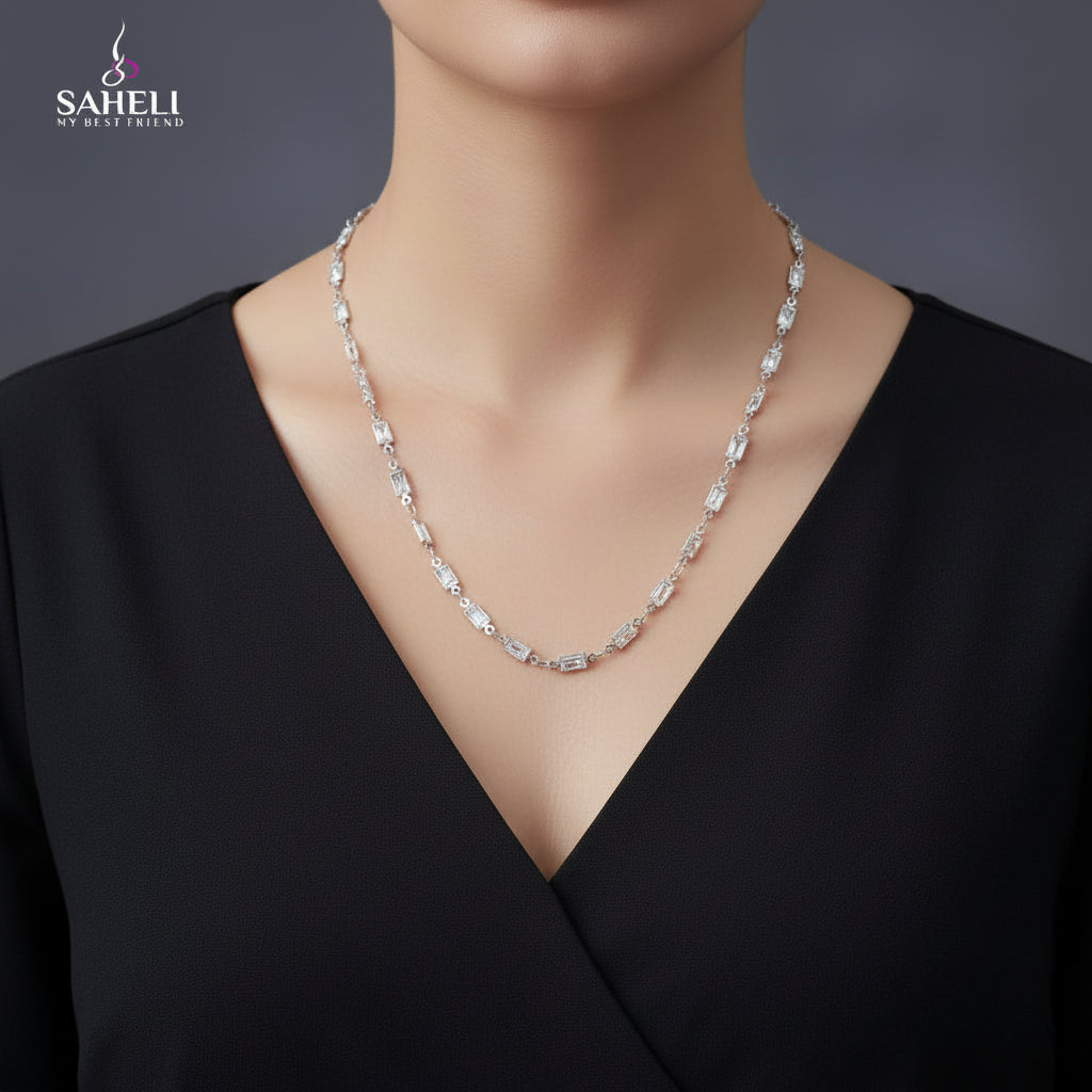 Silver chain necklace on a black mannequin with 'SAHELI' branding.
