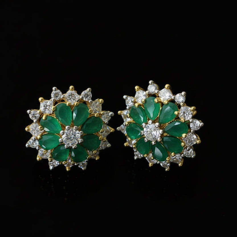 Pair of green gemstone earrings with gold accents on a dark background, branded 'SAHELI'.