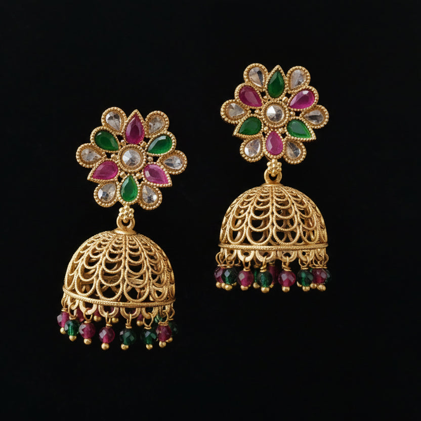 Gold earrings with colorful gemstones on a black background