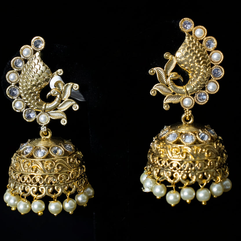 Gold earrings with pearl accents on a black background, branded 'Saheli'.