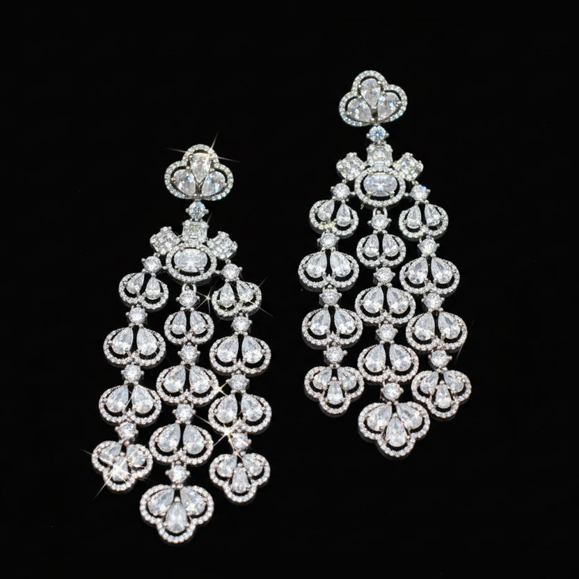 Pair of diamond chandelier earrings on a dark background