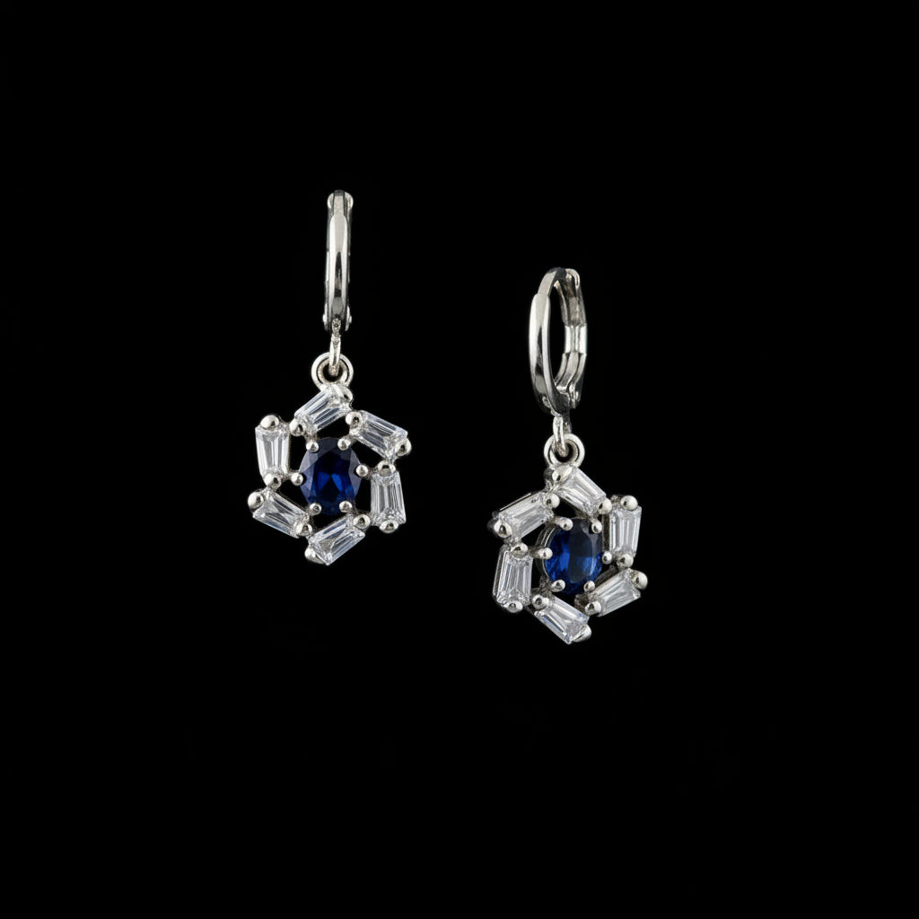 Silver earrings with black gemstones on a dark background, featuring the brand 'Sahelli'.