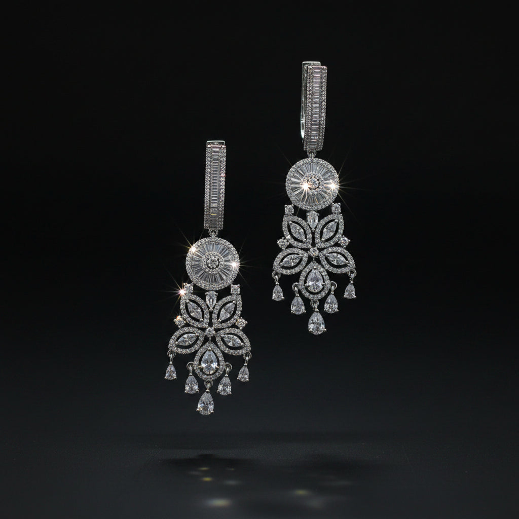 Pair of silver chandelier earrings on a dark background