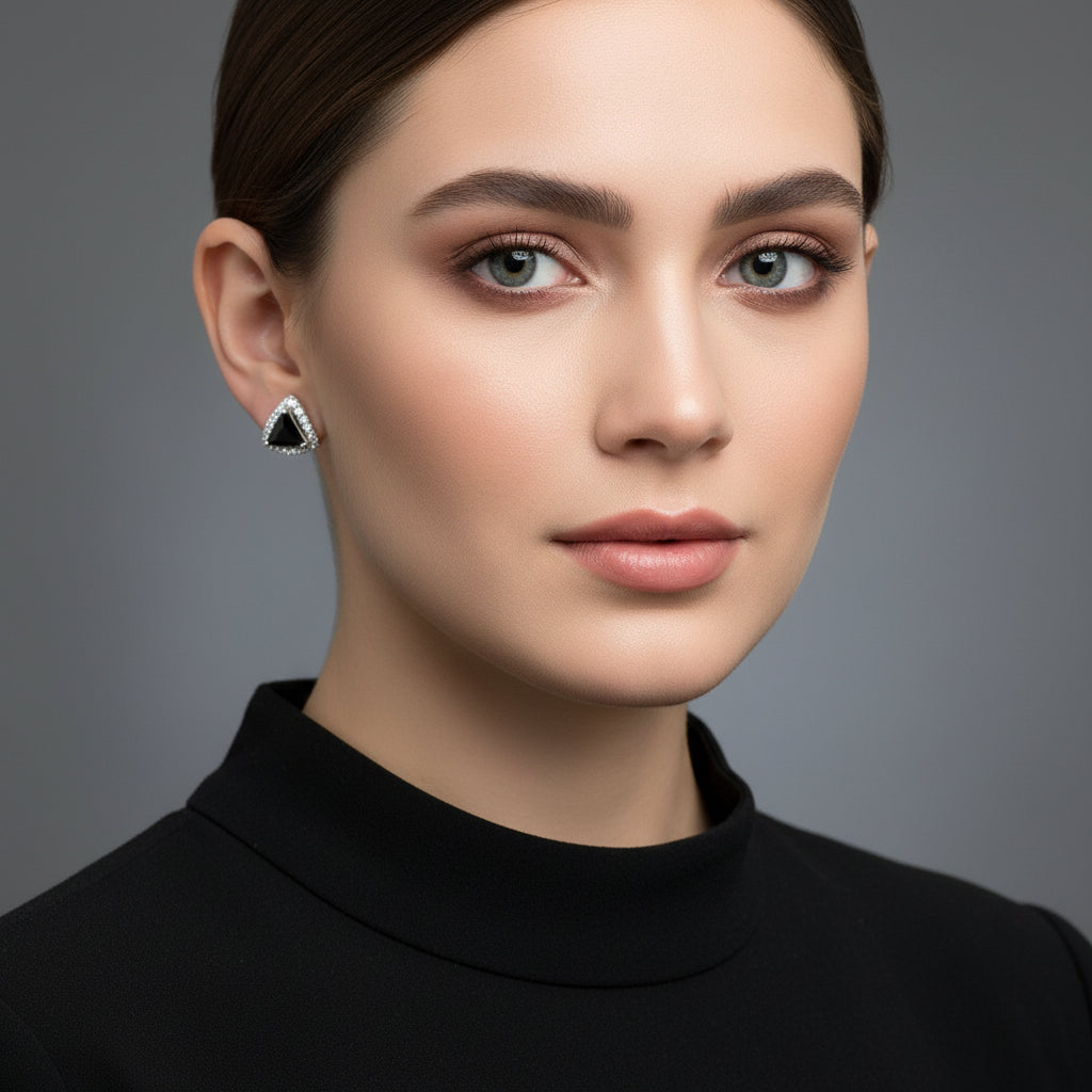 Silver earrings with black stones on a gray cushion, branded 'Saheli My Best Friend' on a dark background.