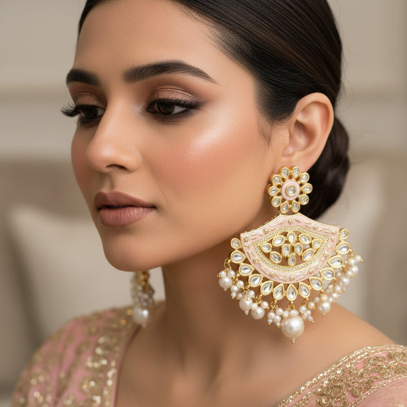 Ornate gold and pearl earrings on a dark background with 'Saheli' branding.