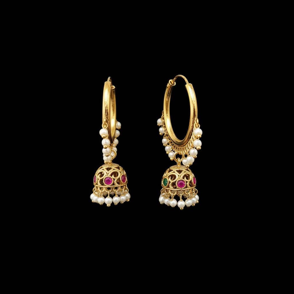 Gold hoop earrings with pearl and gemstone details on a gray stand, branded 'SAHELI'.