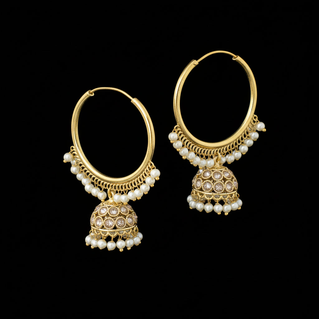 Gold hoop earrings with pearl drops on a black background