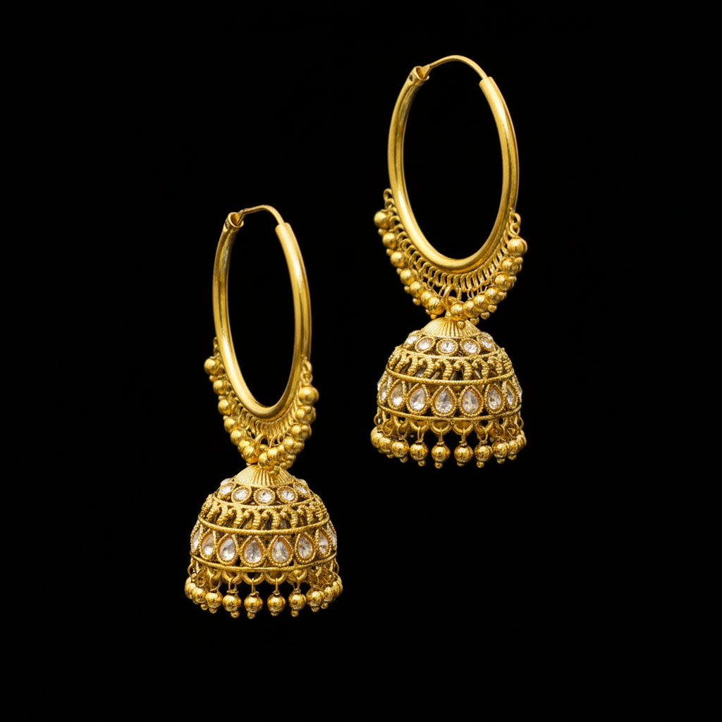 Gold hoop earrings with jhumka designs on a black stand against a gray background.