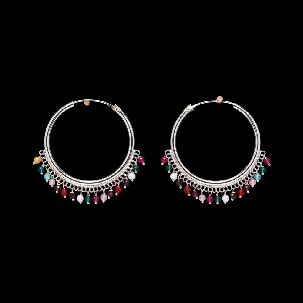 Pair of silver hoop earrings with colorful beads on a brown background