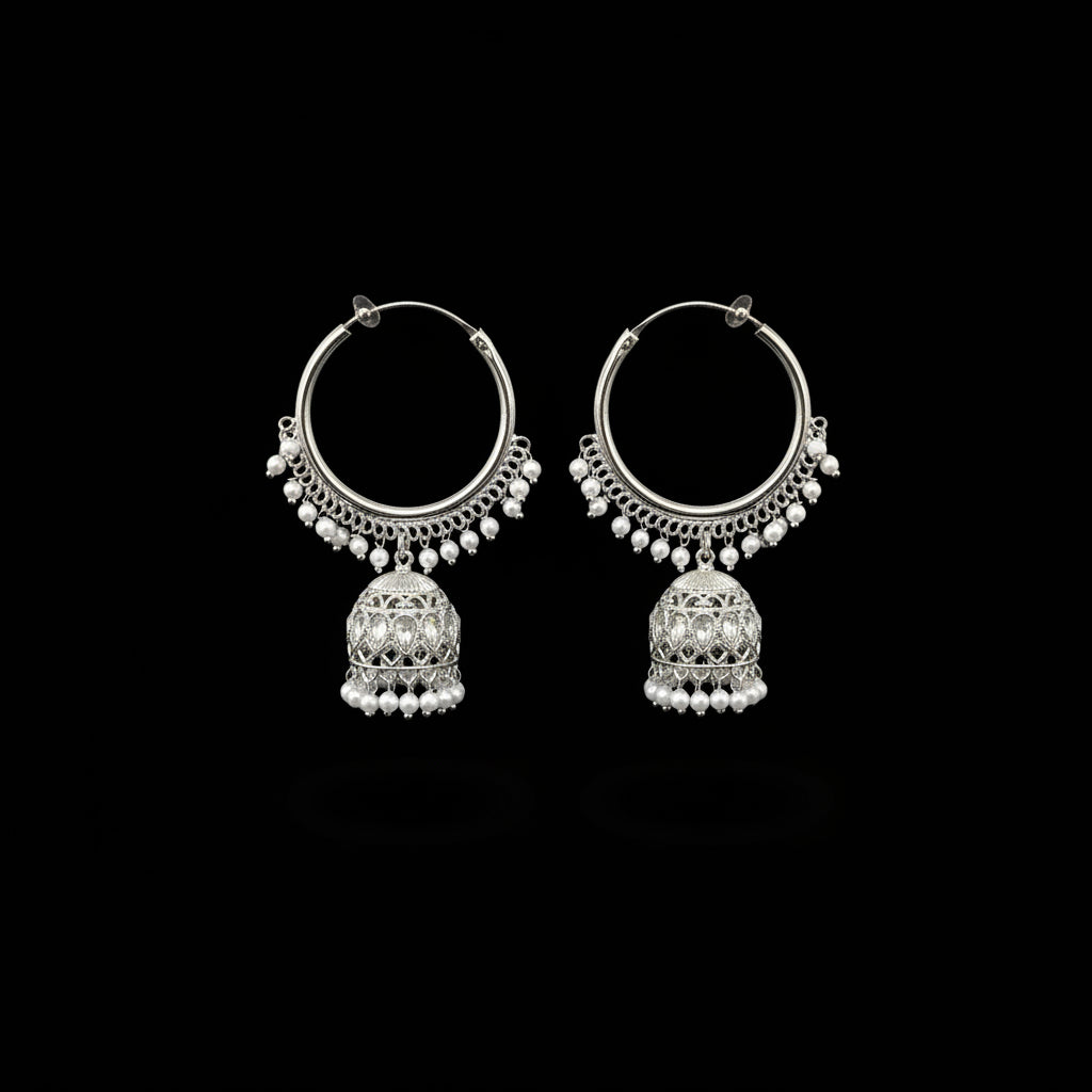 Silver hoop earrings with intricate designs on a black background, featuring the brand 'SAHELI'.