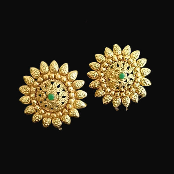 Gold earrings with green gemstones on a dark background, featuring the brand 'SAHELI'.