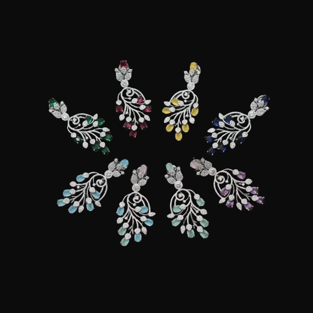 Set of colorful earrings on a dark background with 'Saheli' branding.