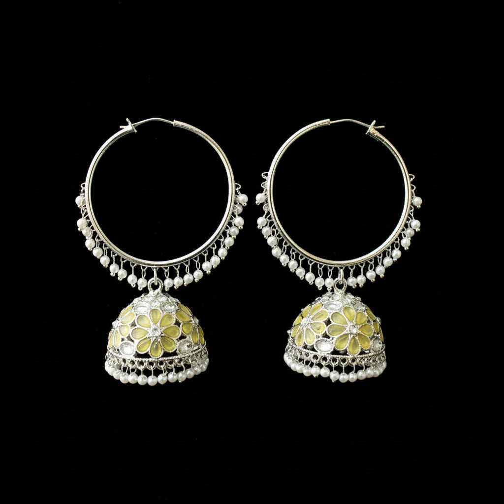 Pair of silver hoop earrings with floral designs on a black background