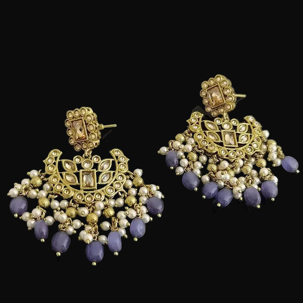 Gold and purple earrings on a dark background