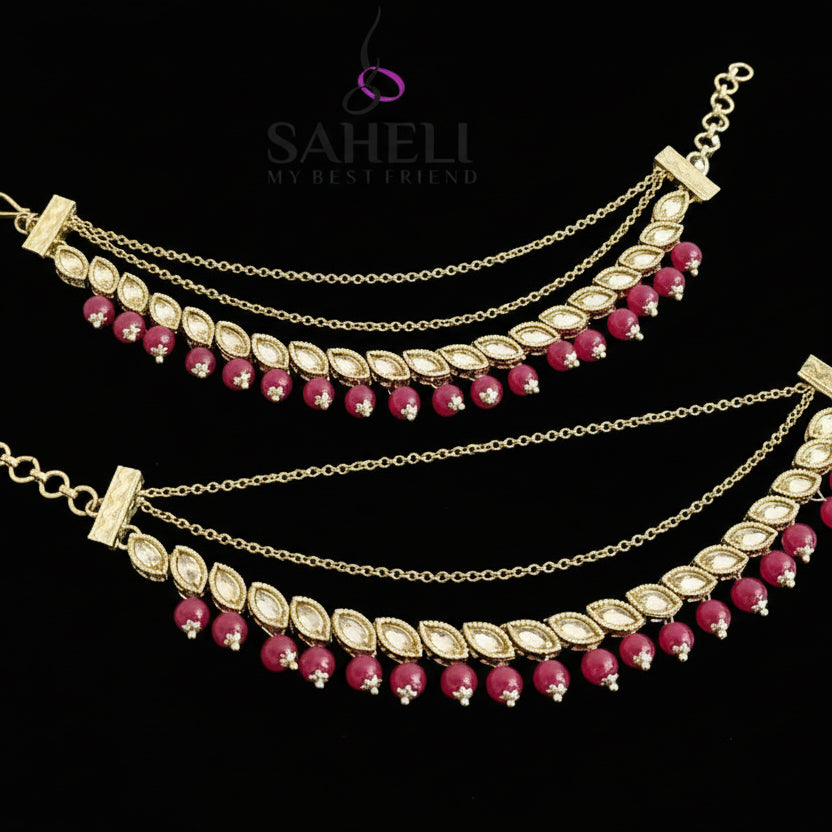 Gold and red beaded anklets on a gray background with 'SAHELI' branding.
