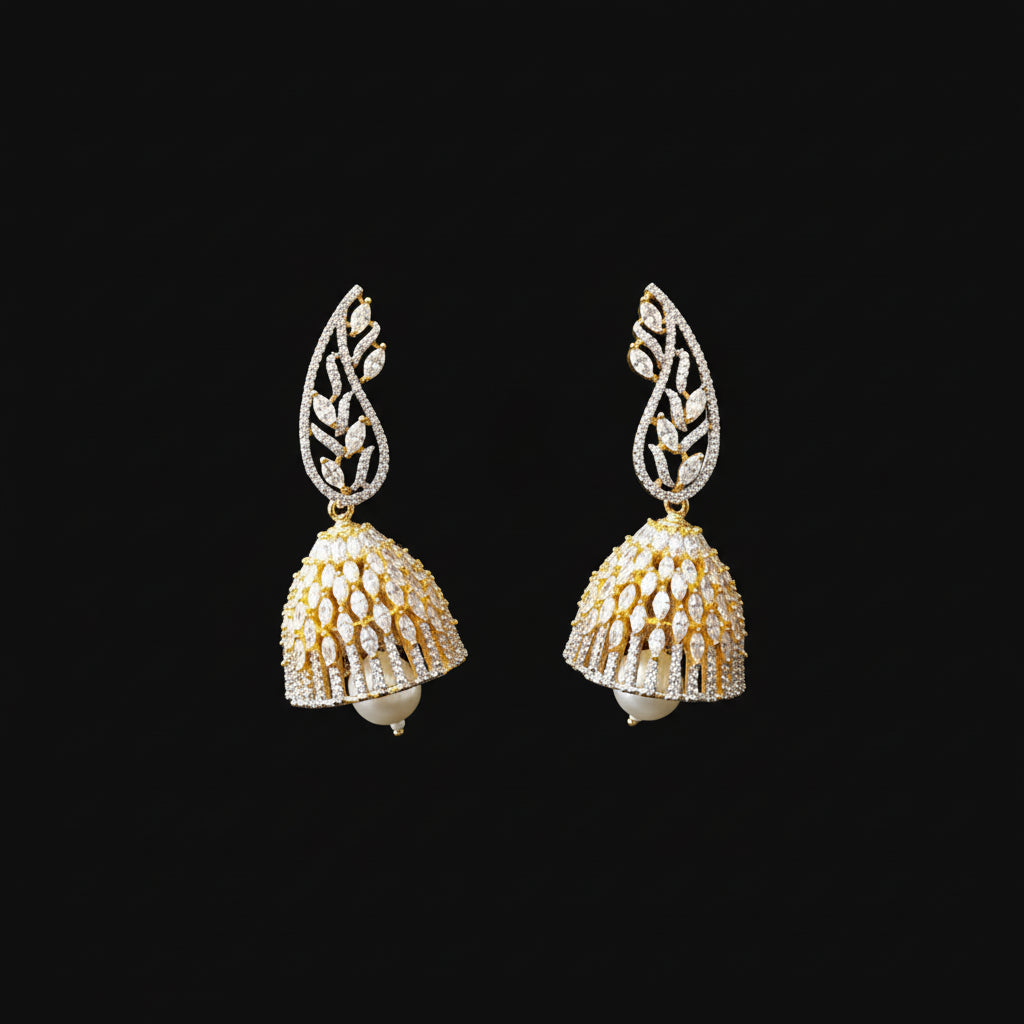 Gold and diamond earrings on a gray stand with 'Saheli' branding.