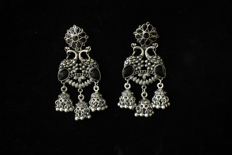 Pair of silver earrings on a black background