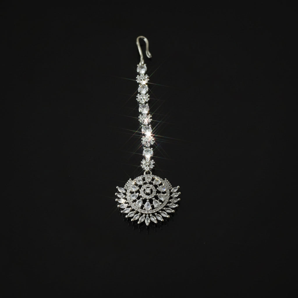 Decorative silver pendant on a black background