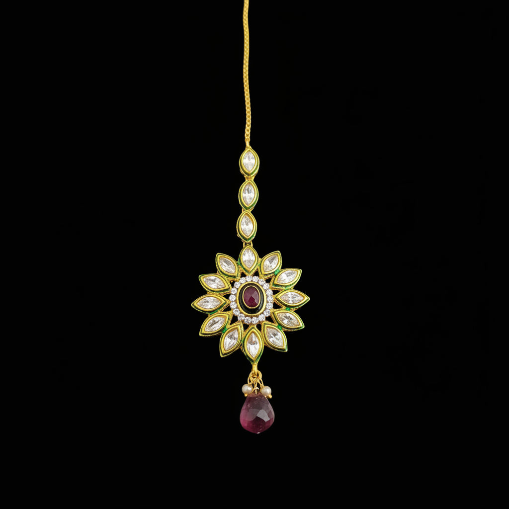 Jewelry item with gemstones on a dark background, featuring the brand 'Saheli'.
