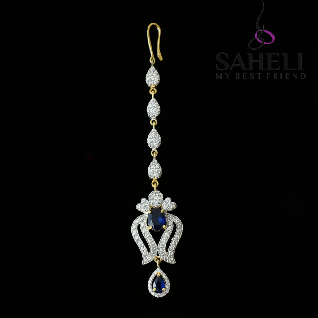 Delicate necklace with gemstones on a dark background, featuring the brand 'Saheli'.