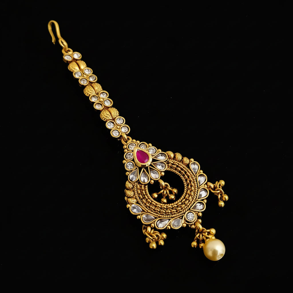 Gold necklace with gemstones on a dark background, branded 'SAHELI'.