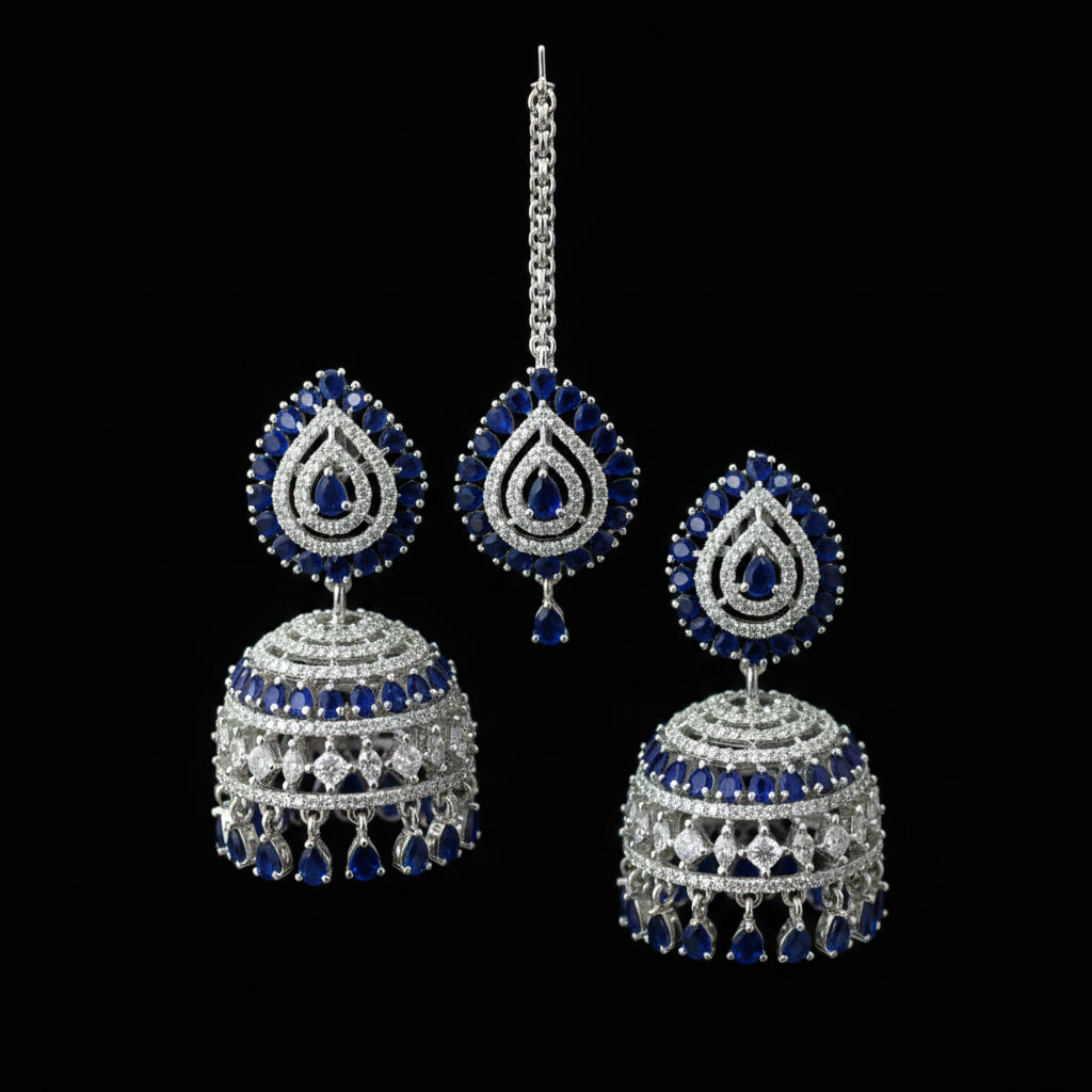 Pair of silver and blue earrings on a black stand with 'SAFA' branding.