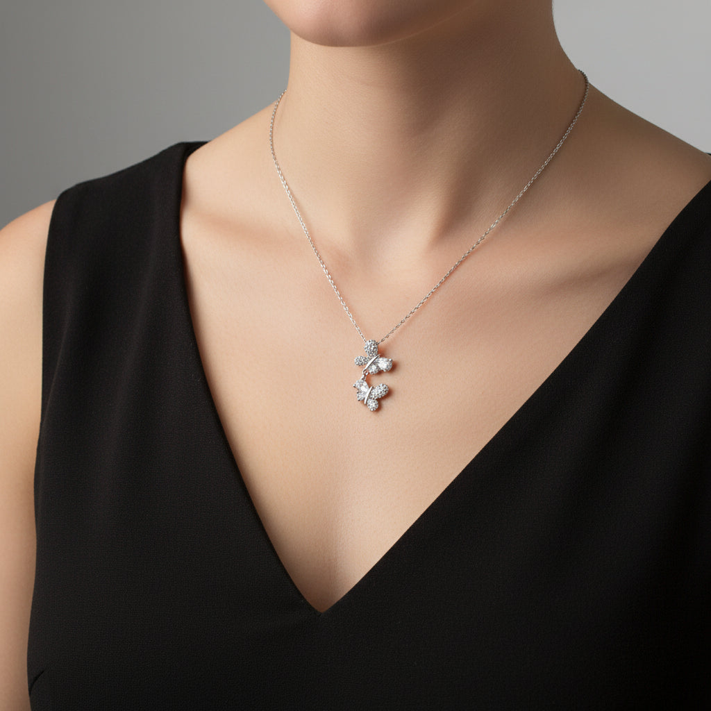 Silver necklace on a branded card with a dark background