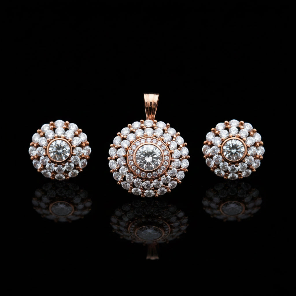 Rose gold jewelry set with pendant and earrings on a gray surface