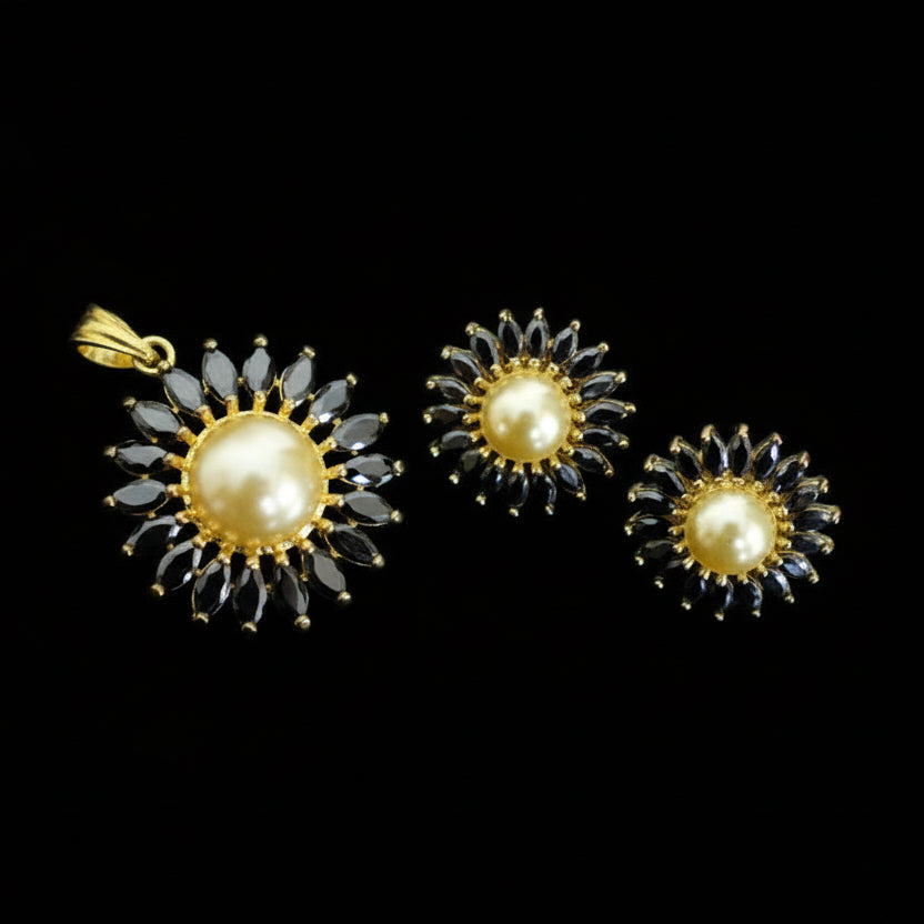 Gold and black earrings with pearls on a dark background, branded 'Saheli'.