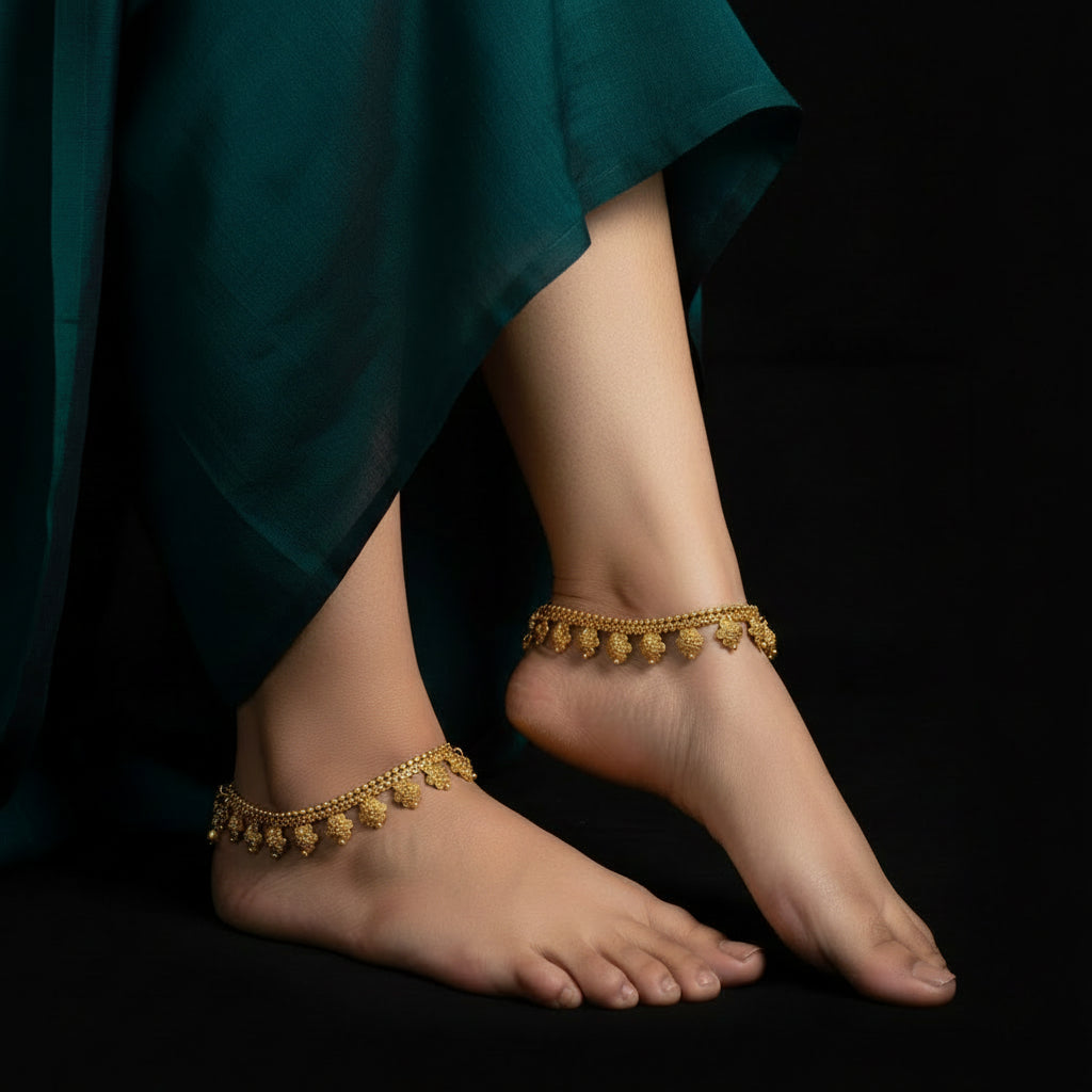 Gold necklace with floral designs on a dark background, featuring the brand 'Saheli'.