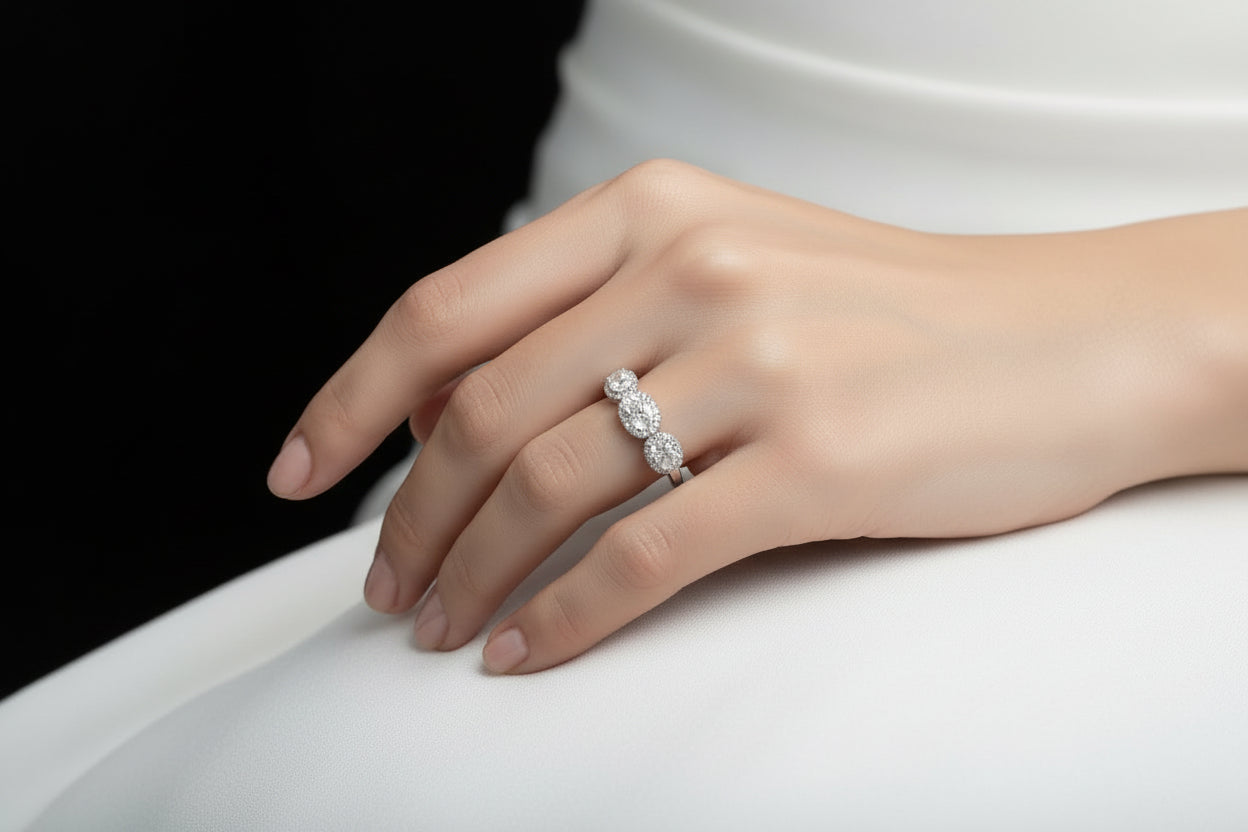 Silver earring on a hand with 'Saheli' branding in the corner.