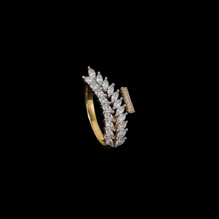 Gold and diamond ring on a black gloved hand with 'SAHELI' branding.