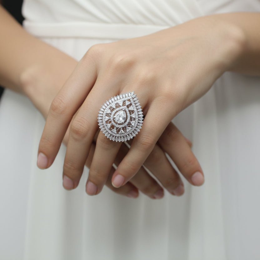 Diamond ring on a black mannequin hand against a dark background