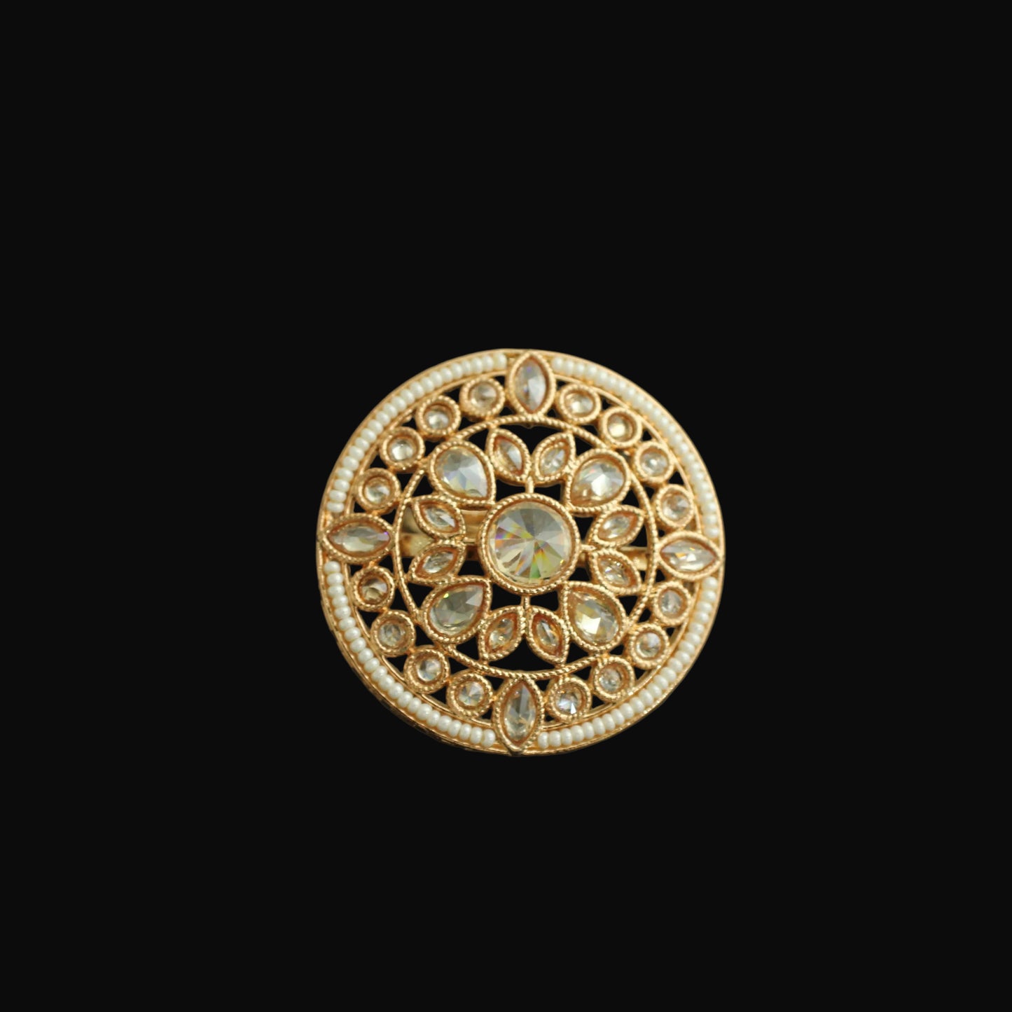 Gold ring with gemstones on a black background
