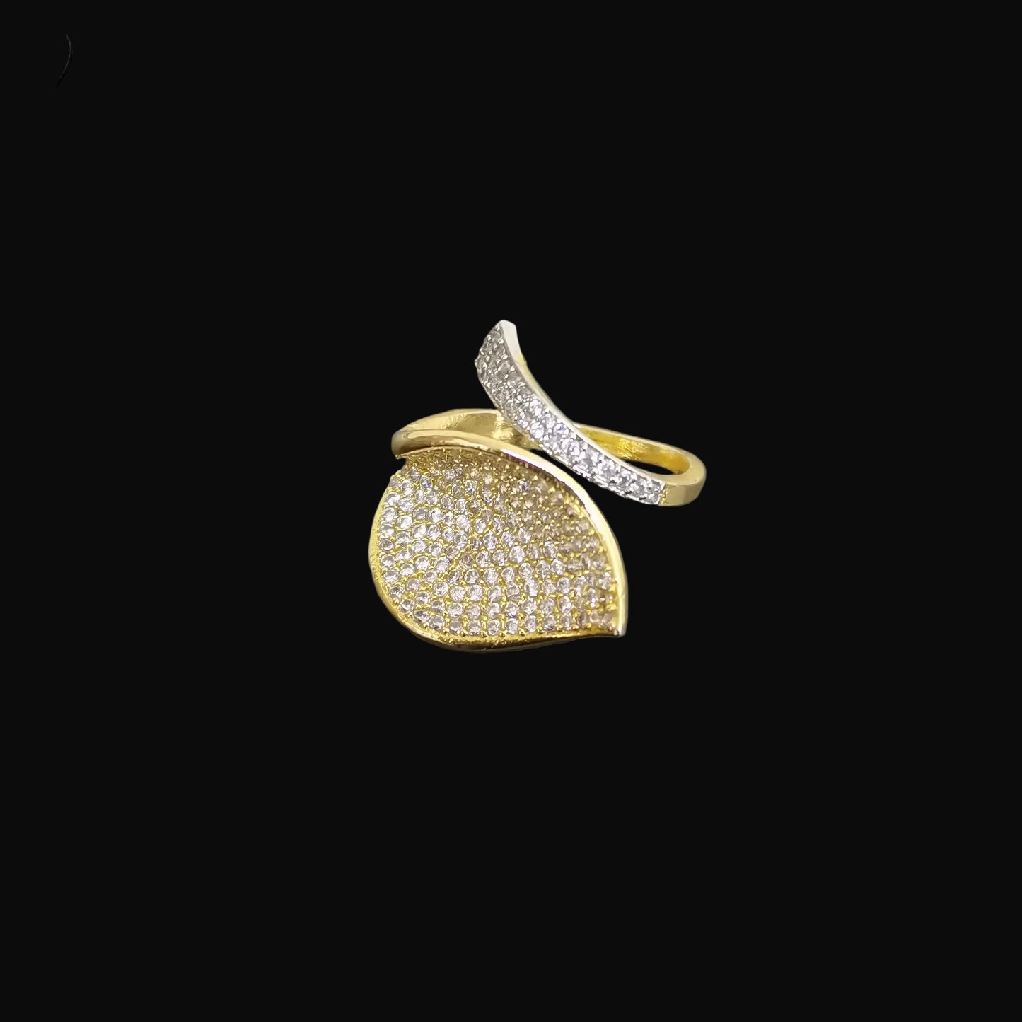 Gold and diamond ring on a gray background with 'Saheli' brand logo.