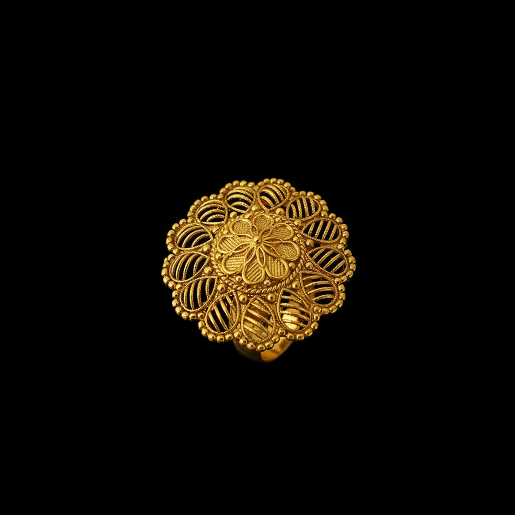 A gold filigree ring with a circular mandala-like floral design, displayed on a black hand against a dark gray background. The brand logo 'SAHELI JEWELLERY' is visible in the top left corner.