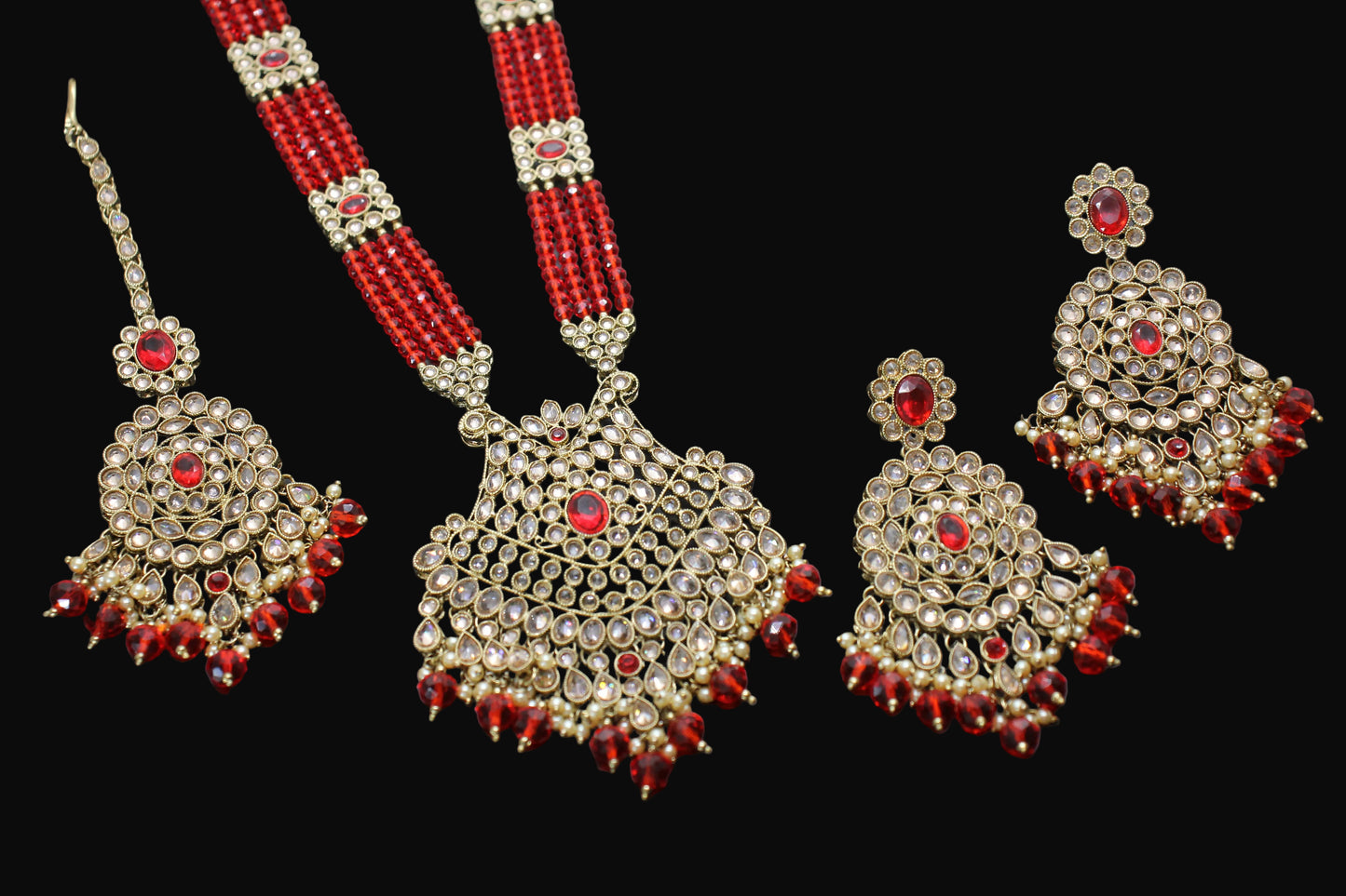 Ornate necklace with matching earrings on a dark background
