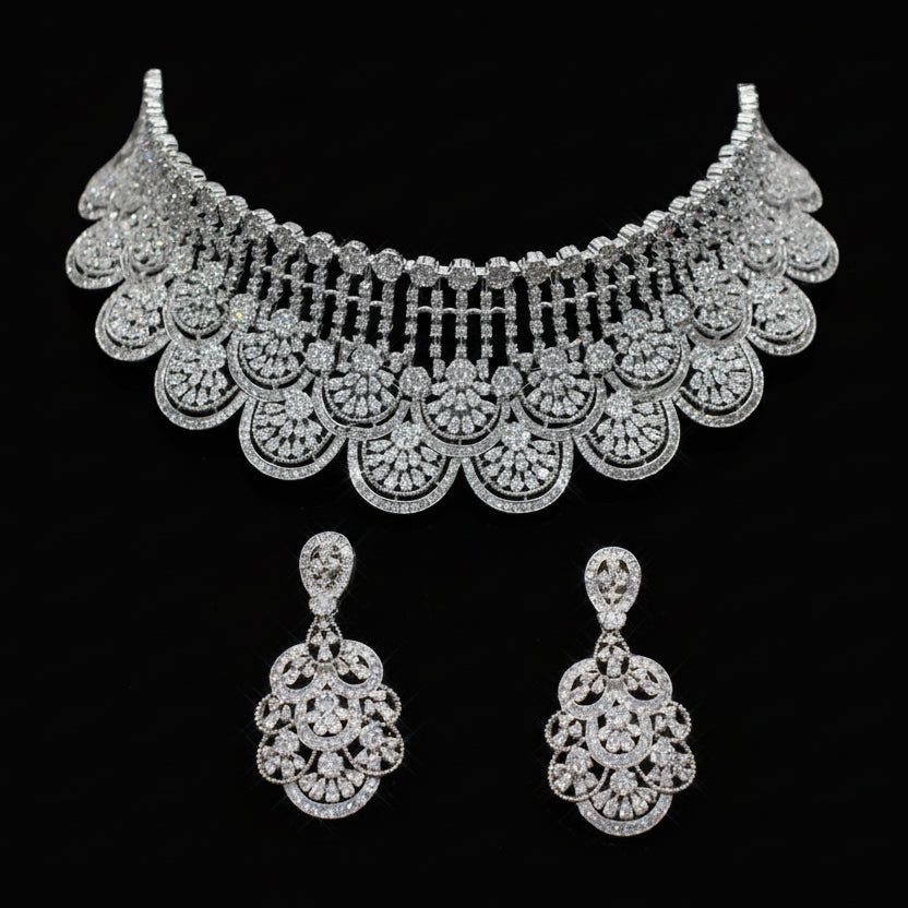 Silver necklace and earrings set on a dark background
