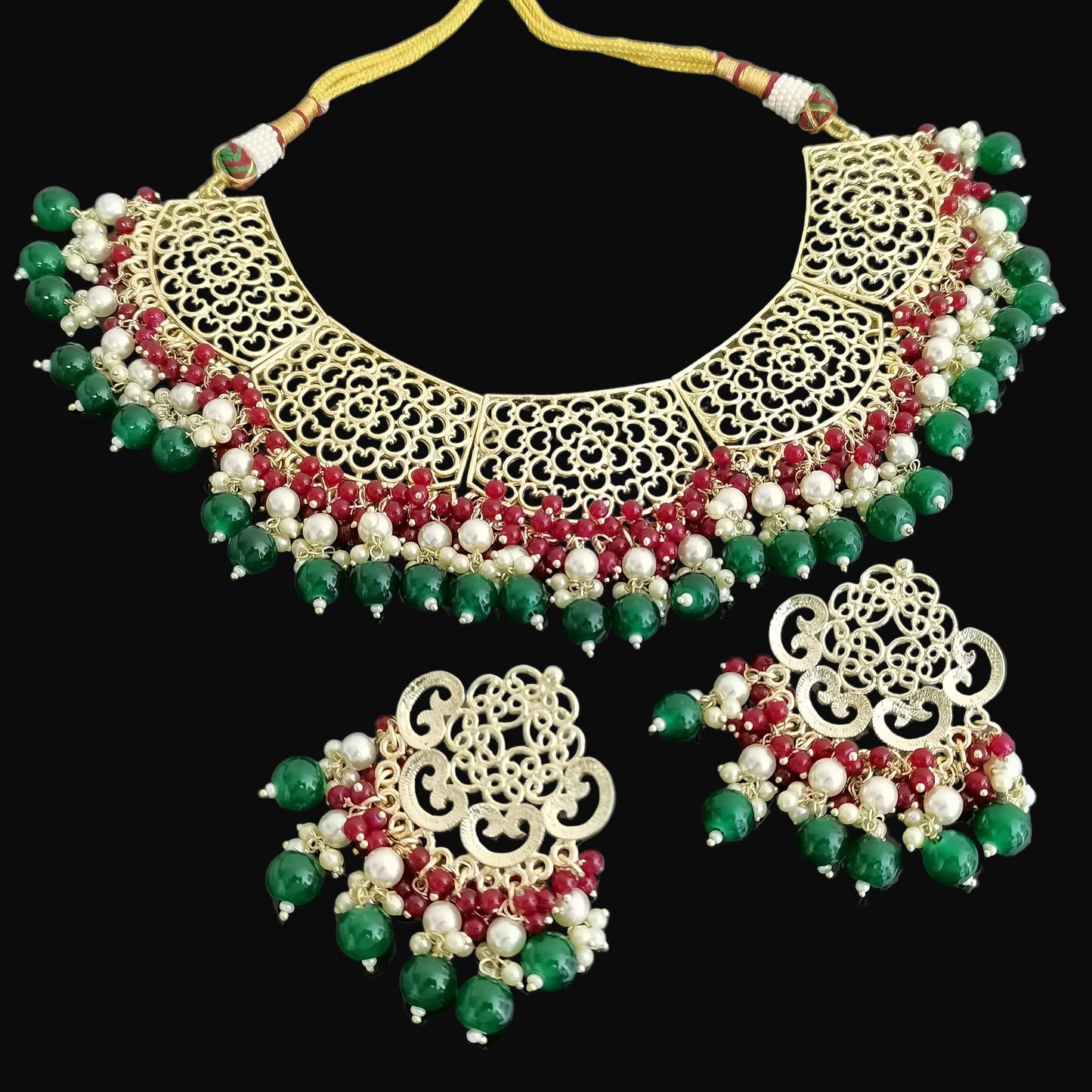 Ornate necklace with matching earrings on a dark background