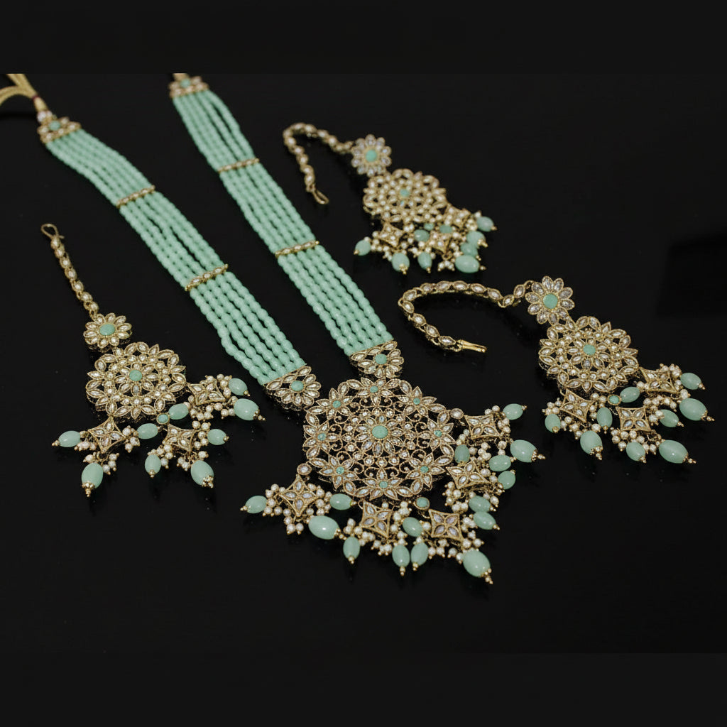 Turquoise beaded necklace with gold and turquoise jewelry on a dark background